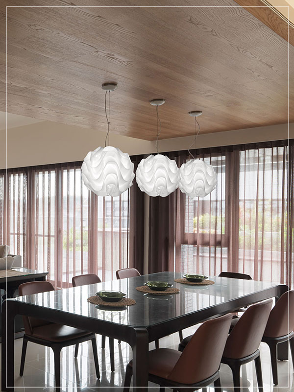 Modular Pendadnt Lamp Shade Wave in a Dining Room.
