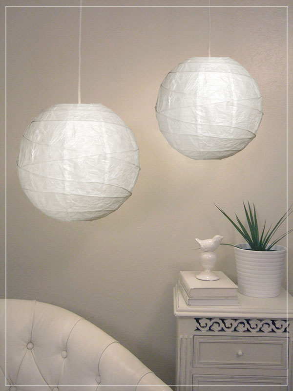 Pendant lantern in white in room.