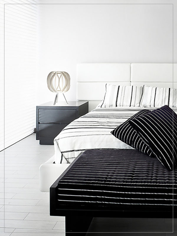 Modern Modular Table lamp shade Luna with tripod in a bedroom.