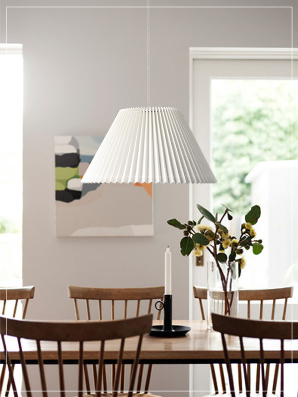 Pendant pleated lampshade in a dining room.